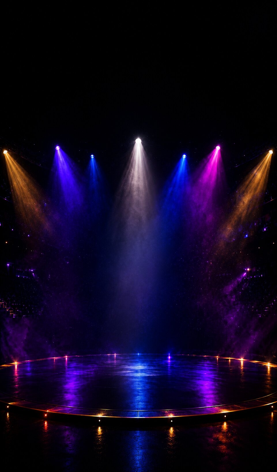 Empty circus stage lit by purple and gold spotlights